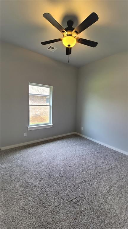 spare room featuring ceiling fan and carpet floors