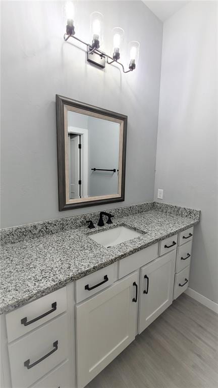 bathroom with vanity and hardwood / wood-style flooring