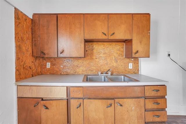 kitchen with hardwood / wood-style floors, decorative backsplash, and sink