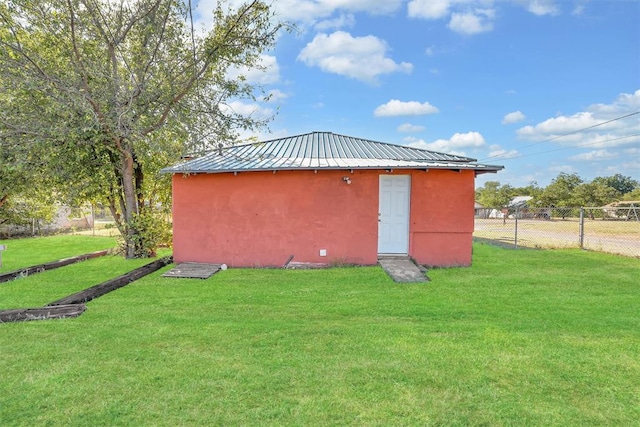 view of outdoor structure featuring a lawn