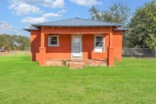 back of house with a yard