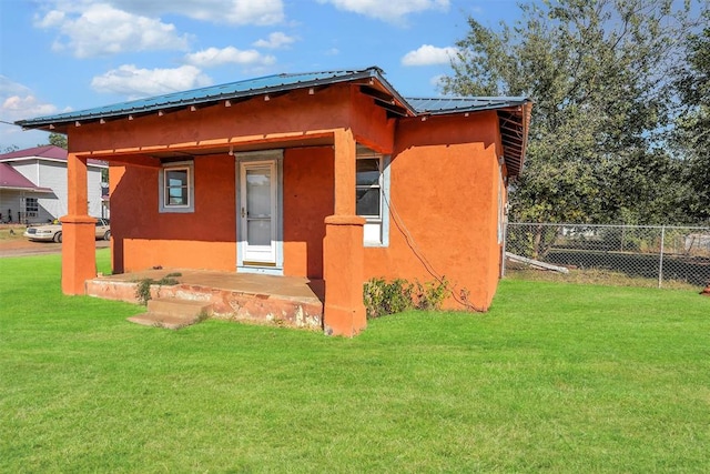 back of property with a lawn