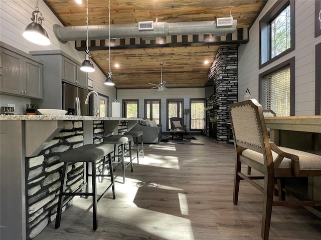 dining room featuring wooden ceiling, high vaulted ceiling, and a healthy amount of sunlight