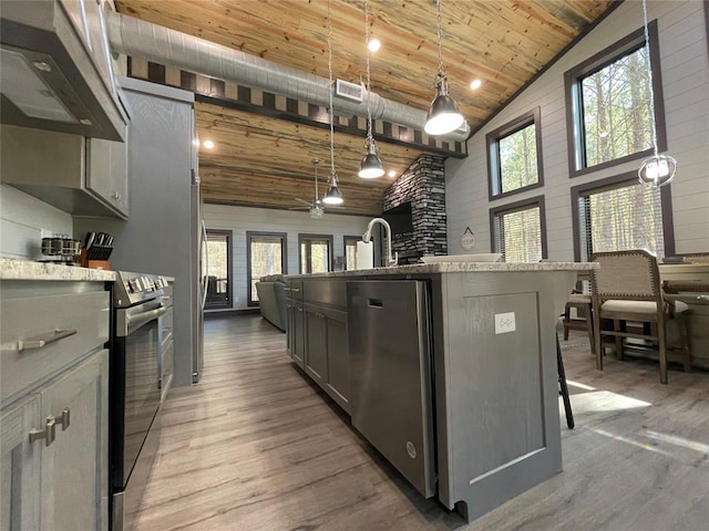 kitchen with gray cabinets, wood ceiling, hanging light fixtures, and a breakfast bar area