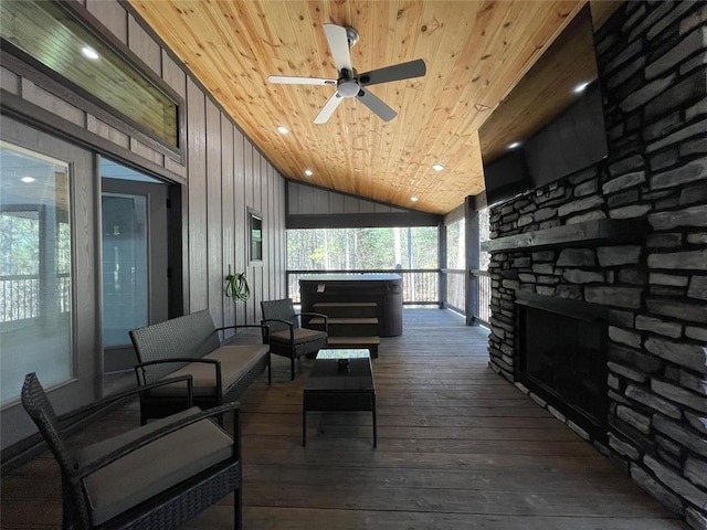 wooden deck featuring an outdoor living space with a fireplace and ceiling fan