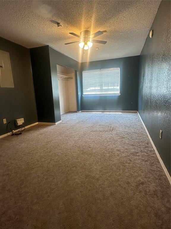 interior space featuring ceiling fan and a textured ceiling