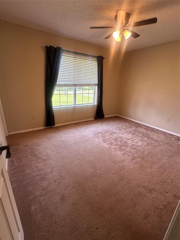 unfurnished room featuring carpet flooring, ceiling fan, and a textured ceiling