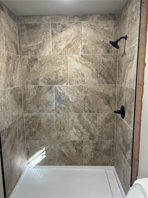 bathroom with tiled shower