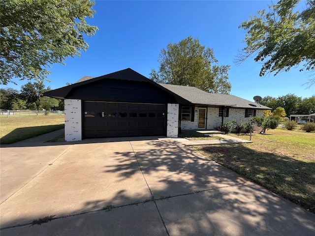 single story home with a garage and a front yard