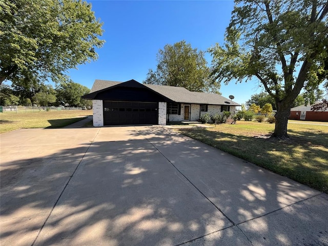 ranch-style house featuring a garage and a front yard