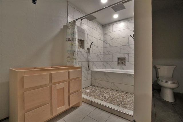 bathroom featuring tile patterned floors, curtained shower, and toilet