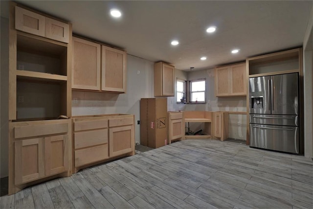 kitchen featuring stainless steel fridge, light wood-type flooring, and light brown cabinets