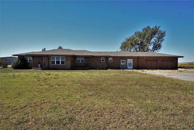 view of front of property with a garage and a front yard