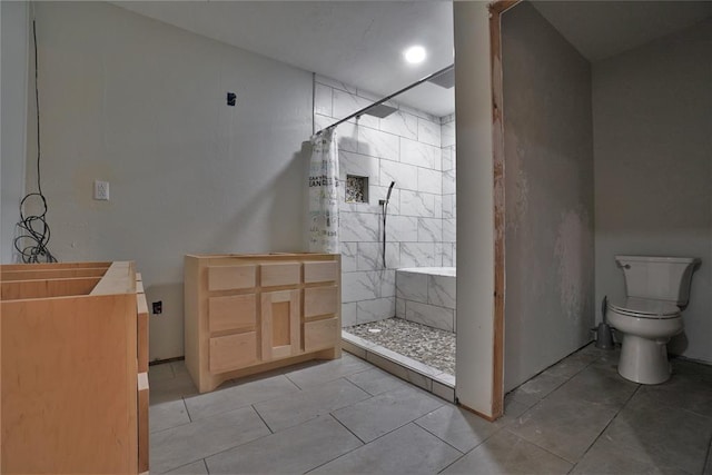 bathroom with tile patterned floors, toilet, and walk in shower