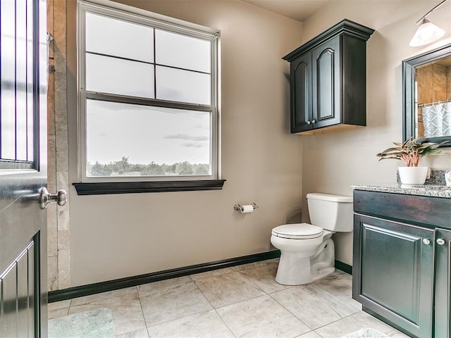 bathroom featuring tile patterned floors, vanity, and toilet