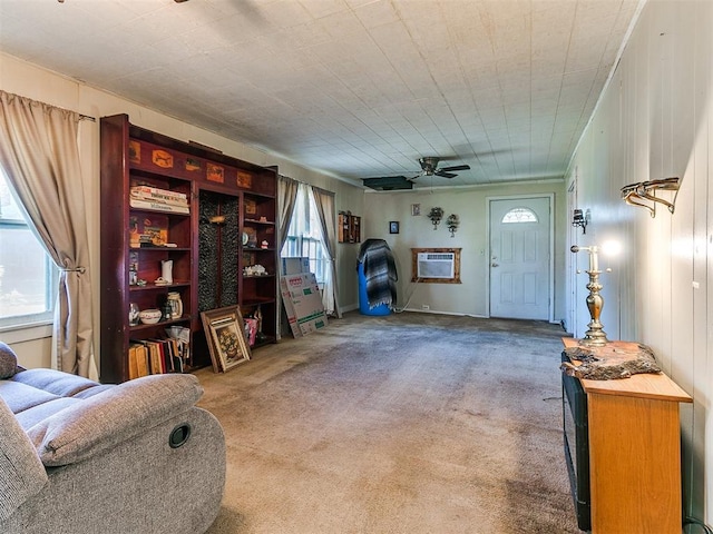 interior space featuring an AC wall unit, ceiling fan, and carpet floors