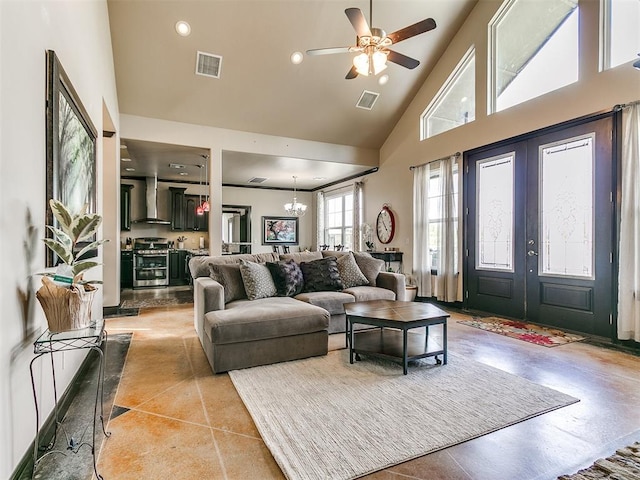 living room with ceiling fan with notable chandelier, high vaulted ceiling, and french doors