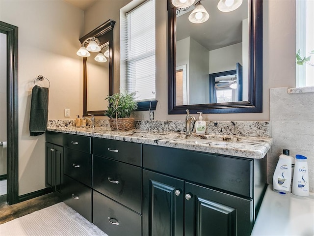 bathroom featuring vanity, a wealth of natural light, and ceiling fan