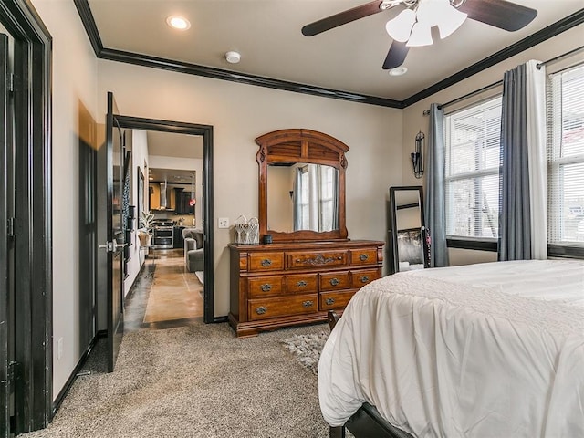 bedroom with dark colored carpet, multiple windows, crown molding, and ceiling fan