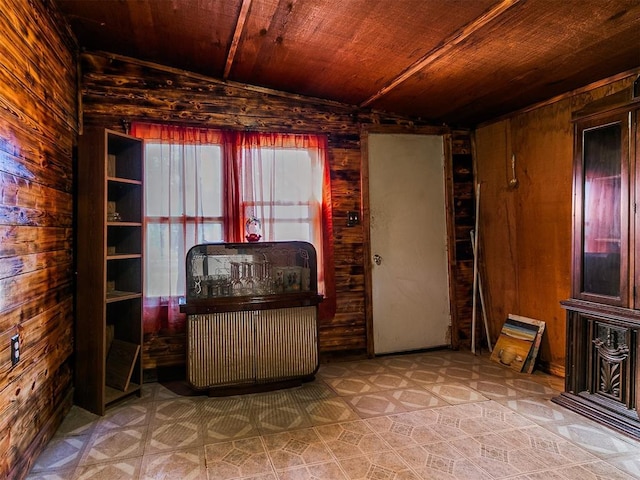 living area featuring wooden walls, lofted ceiling, and wood ceiling