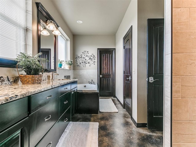 bathroom featuring a bathing tub, vanity, tile walls, and concrete floors