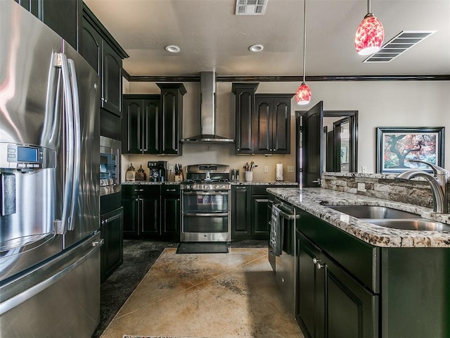 kitchen with sink, wall chimney exhaust hood, stainless steel appliances, crown molding, and pendant lighting