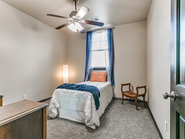 carpeted bedroom with baseboard heating and ceiling fan