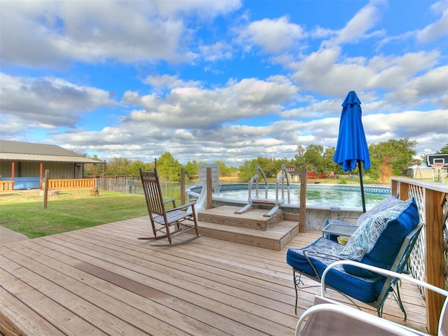 wooden deck featuring a lawn