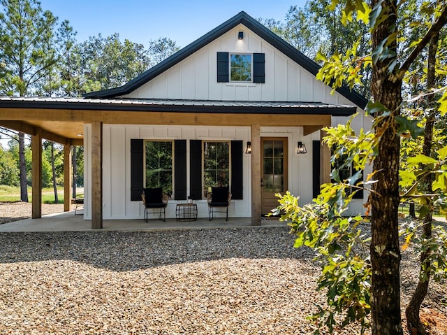 back of property with a porch