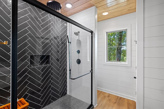 bathroom with hardwood / wood-style flooring, walk in shower, and wooden ceiling