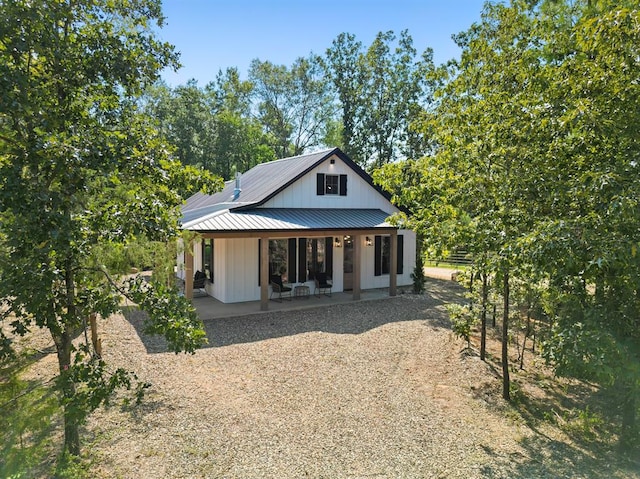 rear view of house with covered porch