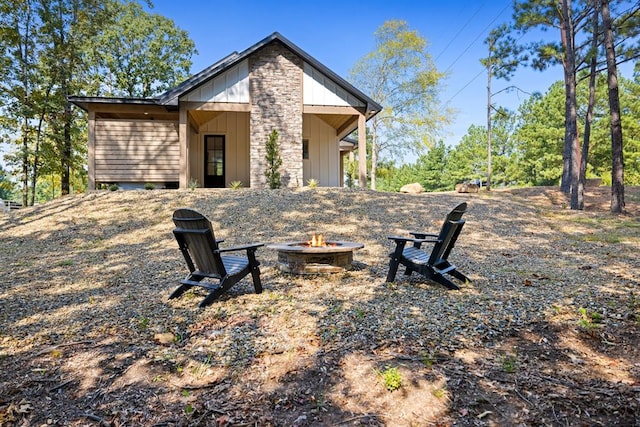 rear view of house featuring a fire pit