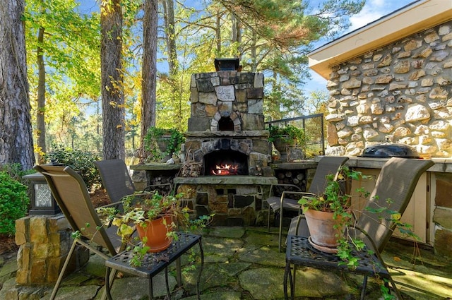 view of patio with an outdoor stone fireplace