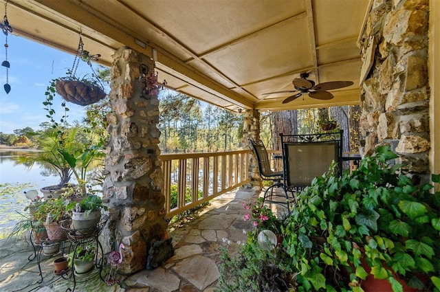 view of patio featuring ceiling fan and a water view