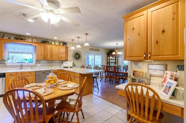 kitchen featuring dishwasher, decorative light fixtures, a healthy amount of sunlight, and sink