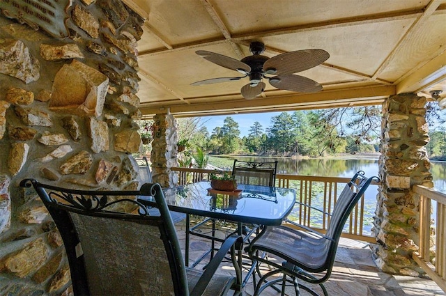 exterior space featuring ceiling fan and a deck with water view