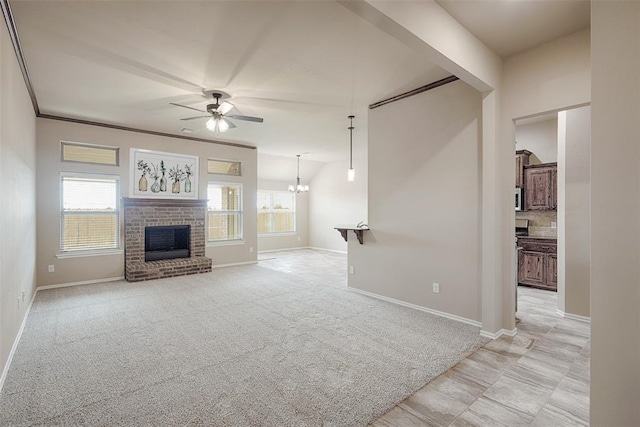 unfurnished living room featuring ceiling fan with notable chandelier, light colored carpet, and a brick fireplace