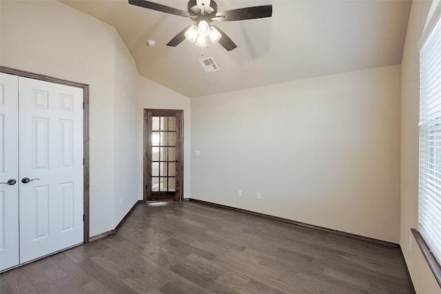 interior space with multiple windows, ceiling fan, dark wood-type flooring, and lofted ceiling