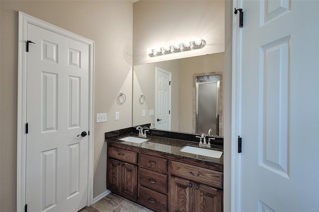 bathroom with vanity and a shower with door