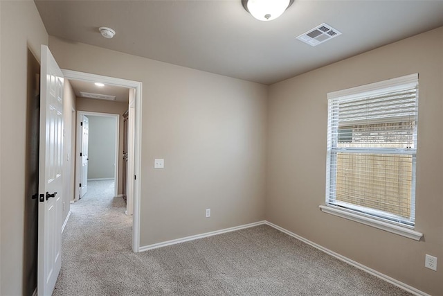 empty room with light colored carpet