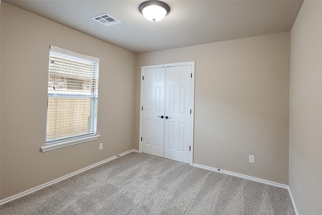 unfurnished bedroom featuring a closet and carpet floors