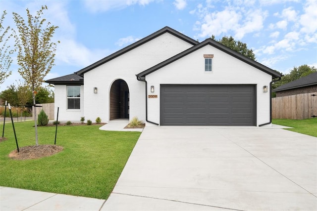 view of front of home featuring a front yard and a garage