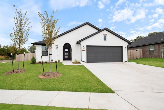 view of front of home with a garage and a front yard