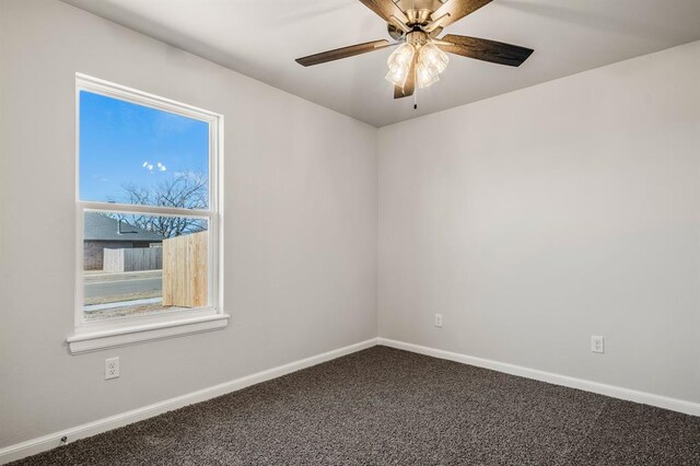 carpeted empty room featuring ceiling fan