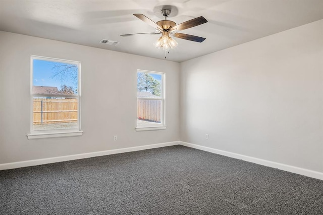 spare room featuring carpet and ceiling fan