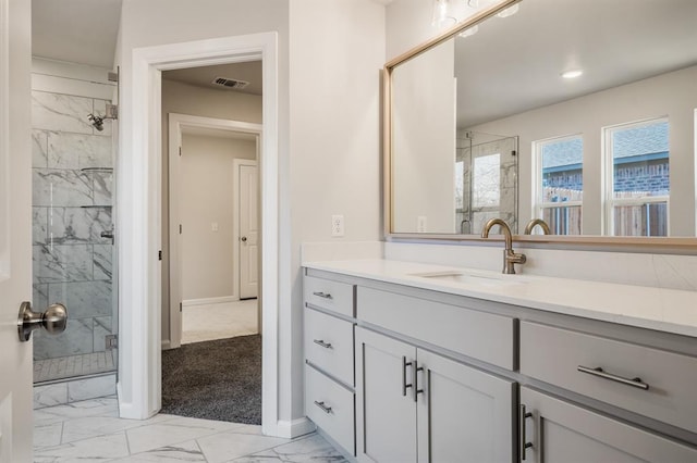 bathroom with vanity and a shower with door