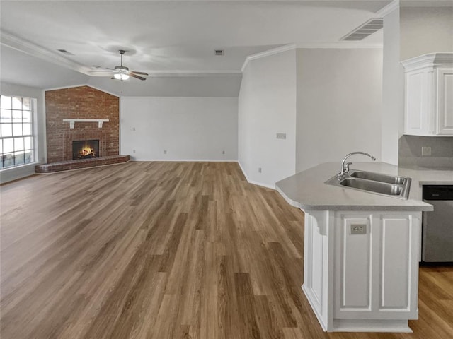 unfurnished living room featuring ceiling fan, sink, crown molding, light hardwood / wood-style floors, and lofted ceiling