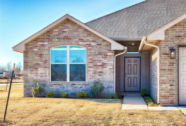 doorway to property with a yard