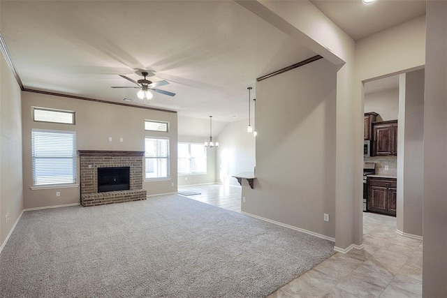 unfurnished living room with ceiling fan with notable chandelier, light colored carpet, and a fireplace