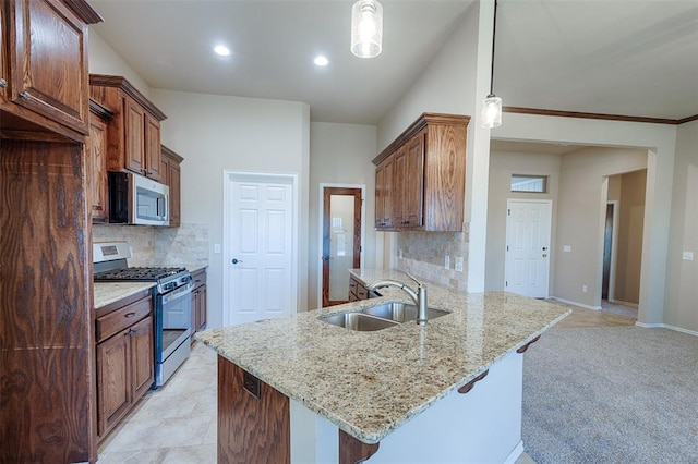 kitchen with sink, light colored carpet, stainless steel appliances, and hanging light fixtures